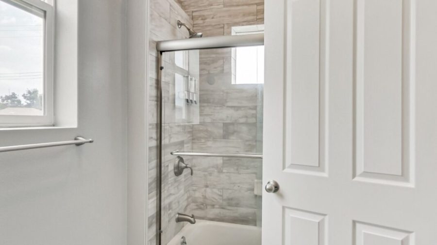 The shared bathroom features a shower over tub layout with Kiehl's shampoo, conditioner, and body wash