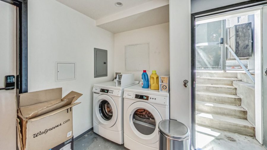 The coin-operated laundry machines are in the basement, accessible through the 4th bedroom's back door.  Go down the stairs to the basement. 