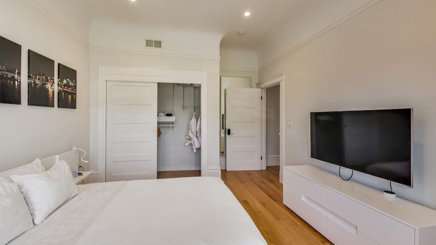 Large and bright bedroom with queen-sized bed, view overlooking Castro St. and 18th, TV with Dish Network and Netflix...