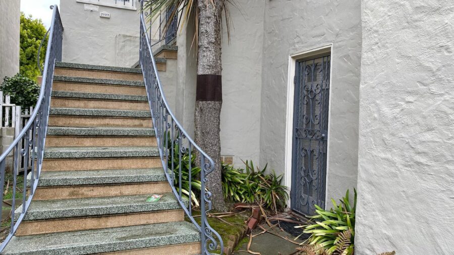 This is your entrance, next to the steps on the right...