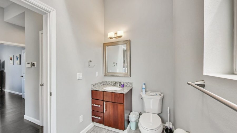 The shared bathroom features a shower over tub layout with Kiehl's shampoo, conditioner, and body wash