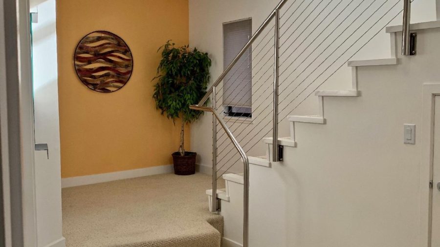 The lower level features three bedrooms, two bathrooms, and a laundry room with front loading washer and dryer
