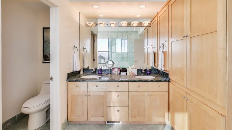 The master bathroom features double sink vanity, separate water closet, a spa bath tub, and a glass enclosed shower