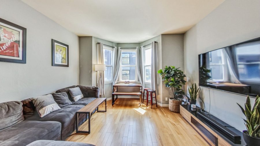 Spacious living room with comfy sofa, dining table and television. 