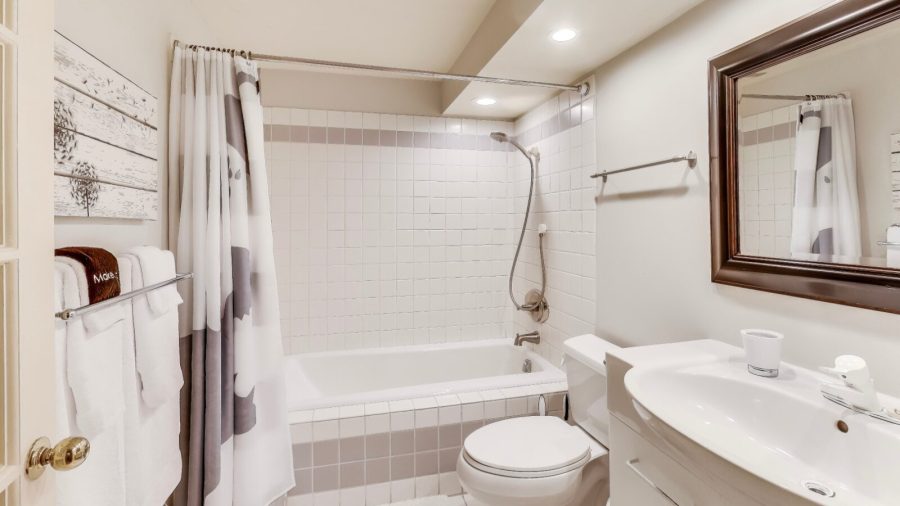 Bathroom with shower over tub