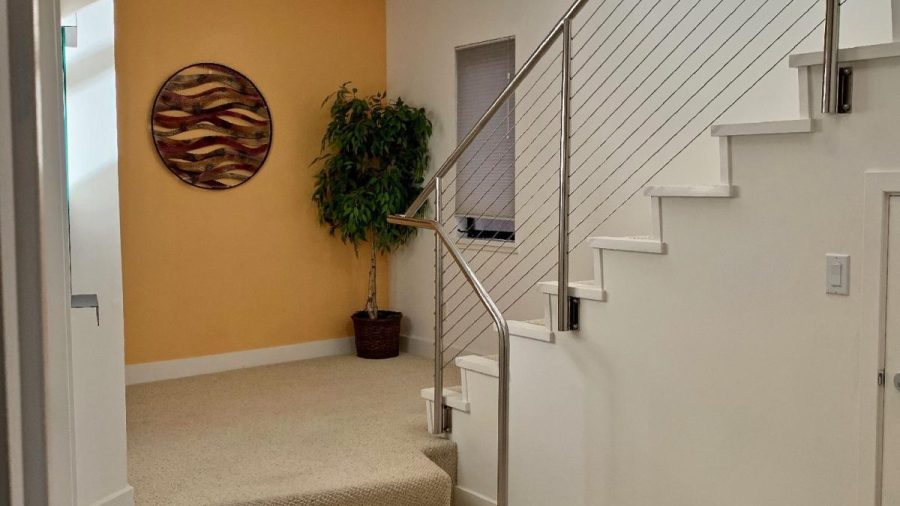The lower level features three bedrooms, two bathrooms, and a laundry room with front loading washer and dryer