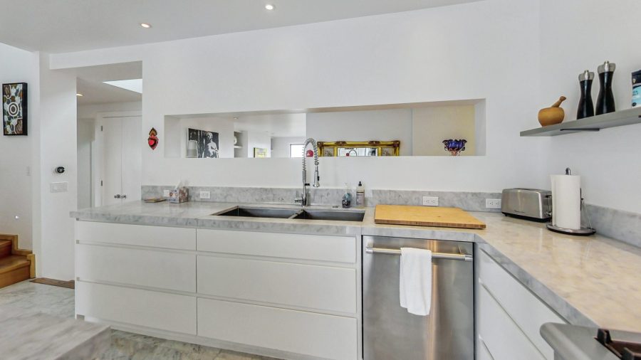 Kitchen with view into the open concept living/dining space. 