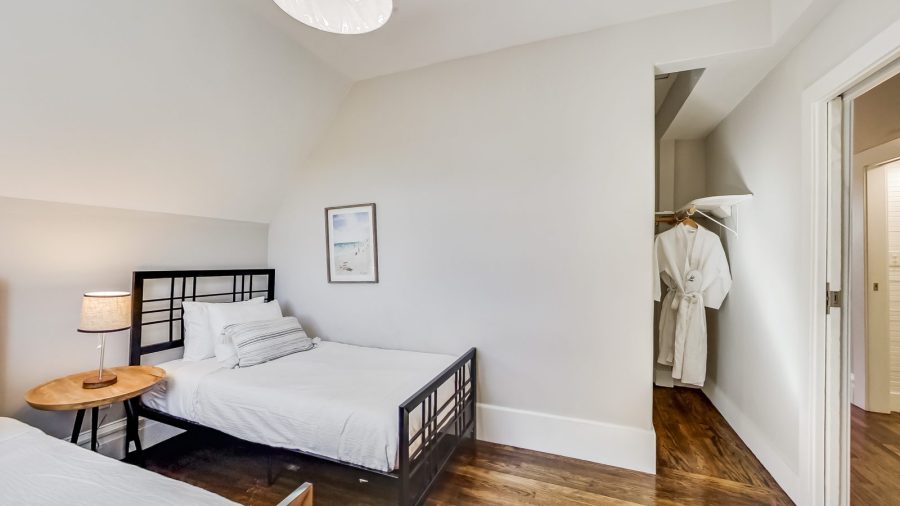 The back upstairs bedroom is just next to the bathroom and features two twin beds and a large closet