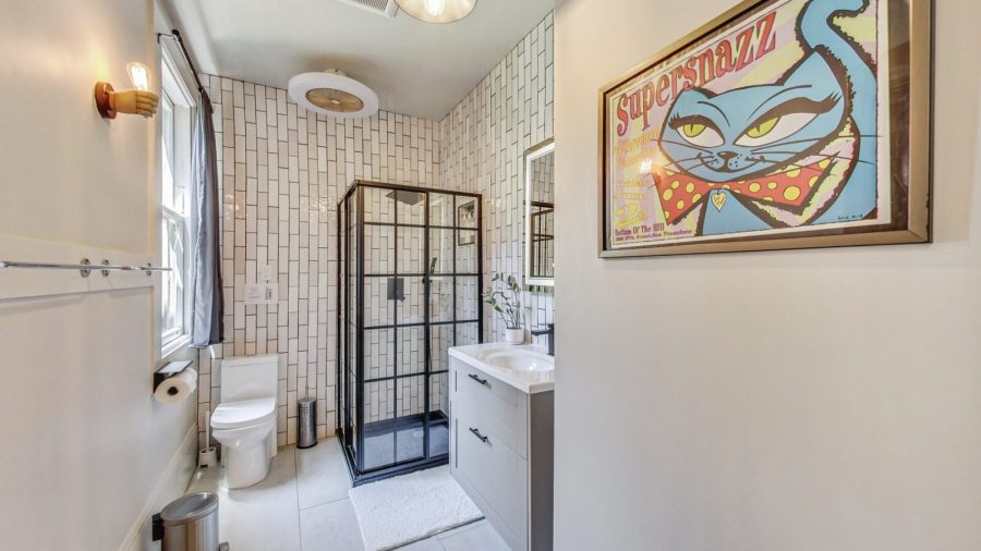 The hallway bathroom has been recently remodeled and has a standards sized shower stall with rainfall shower head.