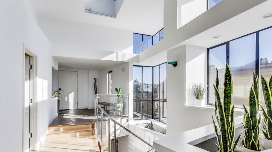 A bright, open, and welcoming entry way with a staircase to the bedrooms on the lower level of the home