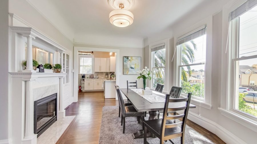 Spacious dining room with decorative fireplace and plenty of room for Eight people