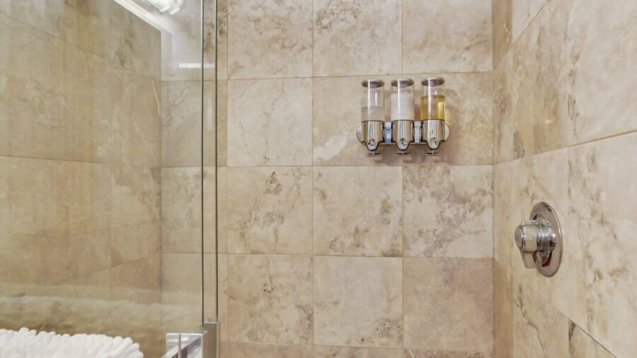 Spacious walk-in  shower with glass shower door.  Lots of light gets into the shower where you will enjoy Kiehl's bath products.