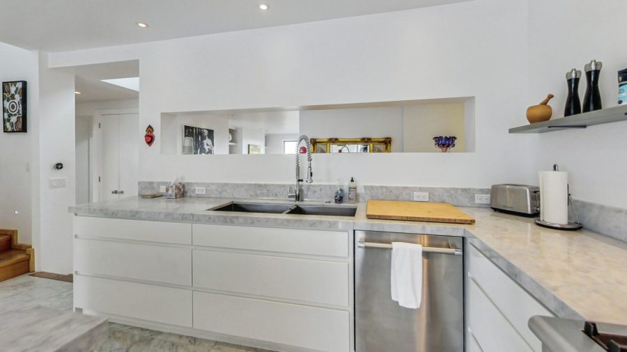 Kitchen with view into the open concept living/dining space. 