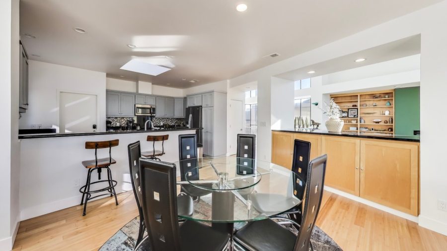 The dining room seats six guests. There is additional bar stool seating for two adjacent to the dining table with views into the open kitchen
