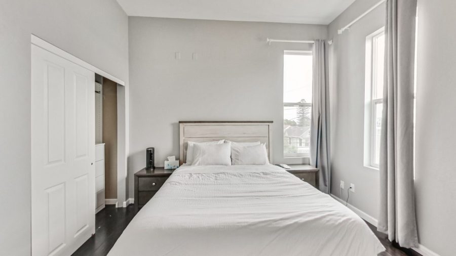 Queen sized bed with window out to the street. 