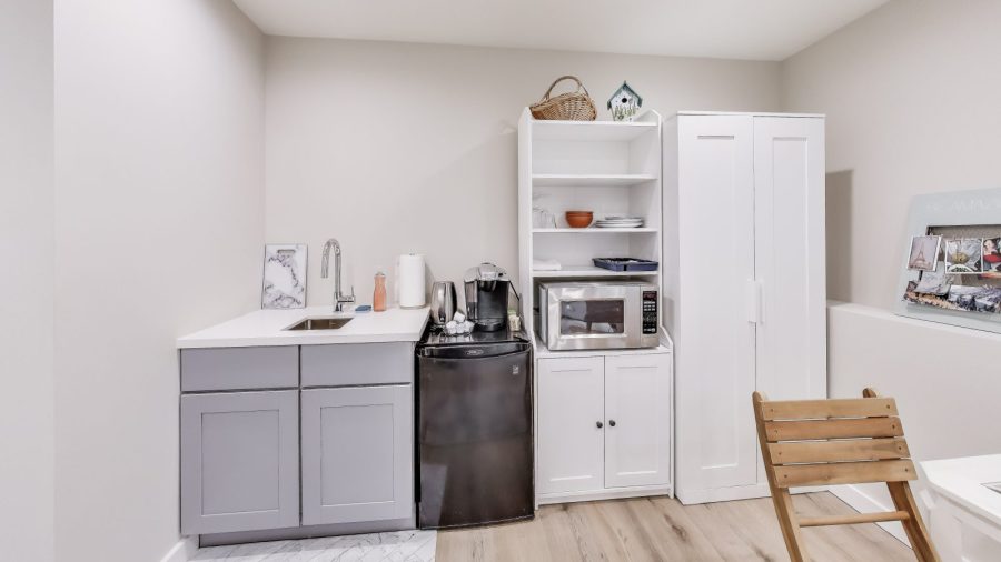 Kitchen area has a small fridge for storing leftovers, a microwave for re-heating them, and a keurig to make coffee or tea.