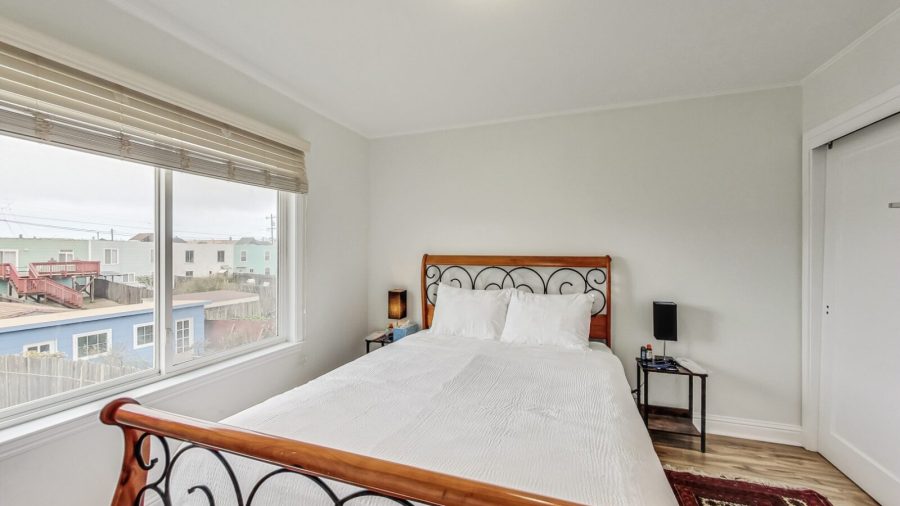 Third bedroom At the end of the hall in the back of the house is a bedroom with a Queen bed.   End Table lamps with USB ports for easy device charging
