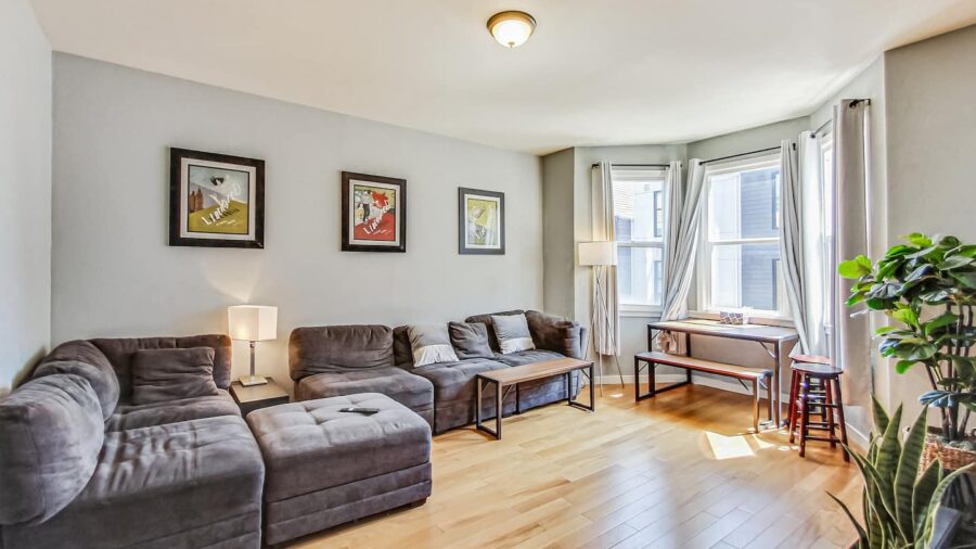 Spacious living room with comfy sofa, dining table and television. 