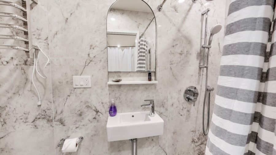 The cozy bathroom has a full shower with removable shower arm for a spa like shower.
