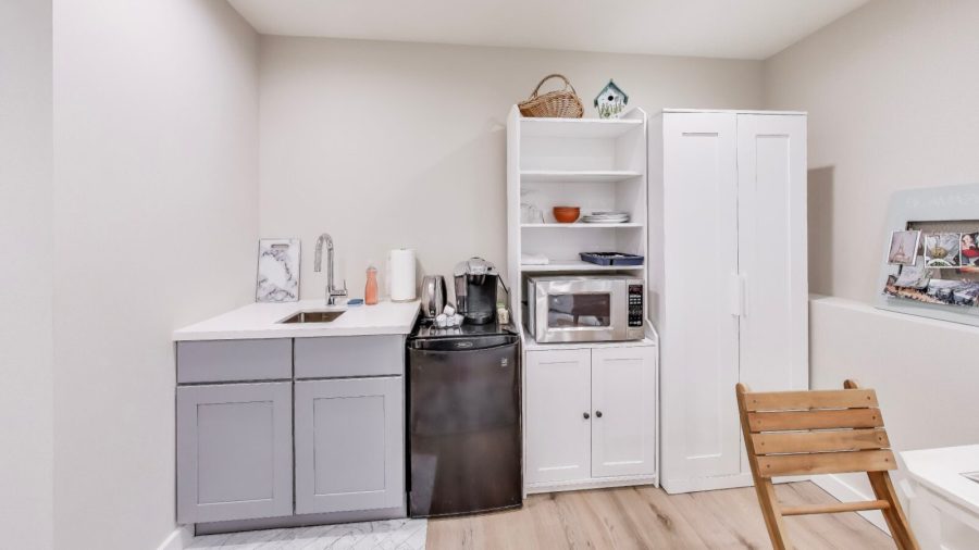 Kitchen area has a small fridge for storing leftovers, a microwave for re-heating them, and a keurig to make coffee or tea.