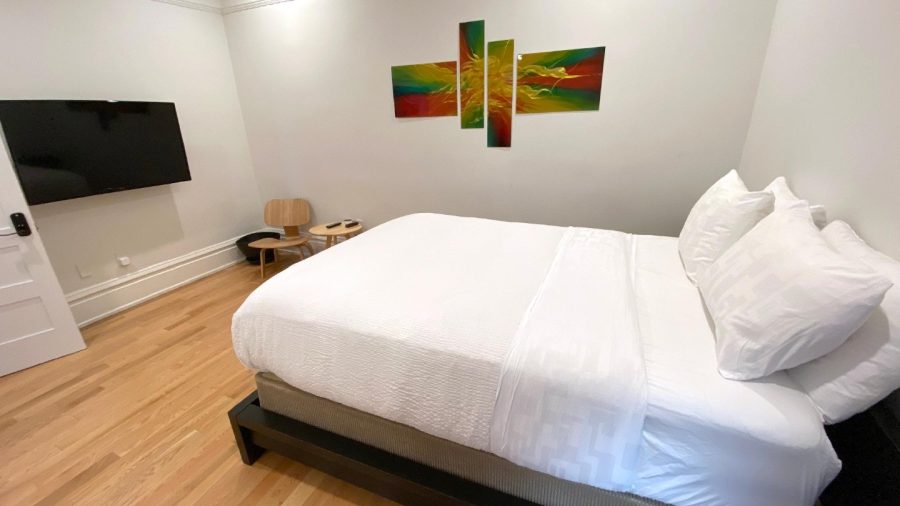 Inside the Master Bedroom Suite...View of the TV with Dish Network & Netflix, next to the door into shared hallway, and the queen-sized bed...