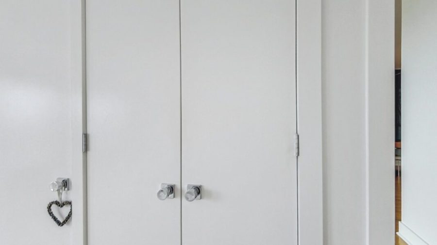 Main floor queen bedroom with en suite bath has plenty of closet space to store clothes. 