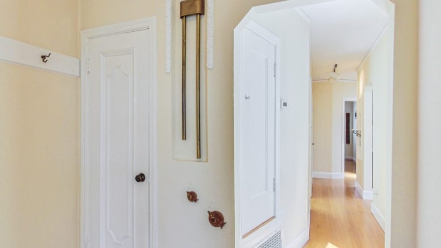 Entry foyer with coat and storage closet.