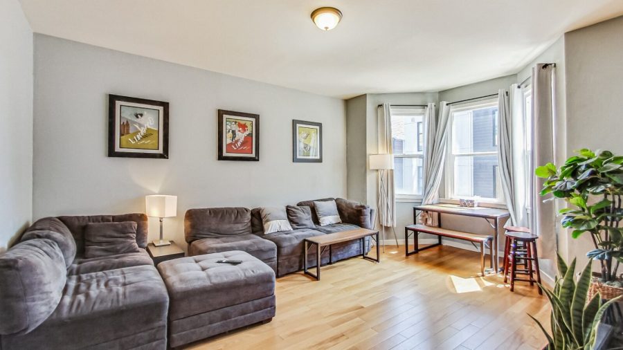 Spacious living room with comfy sofa, dining table and television. 