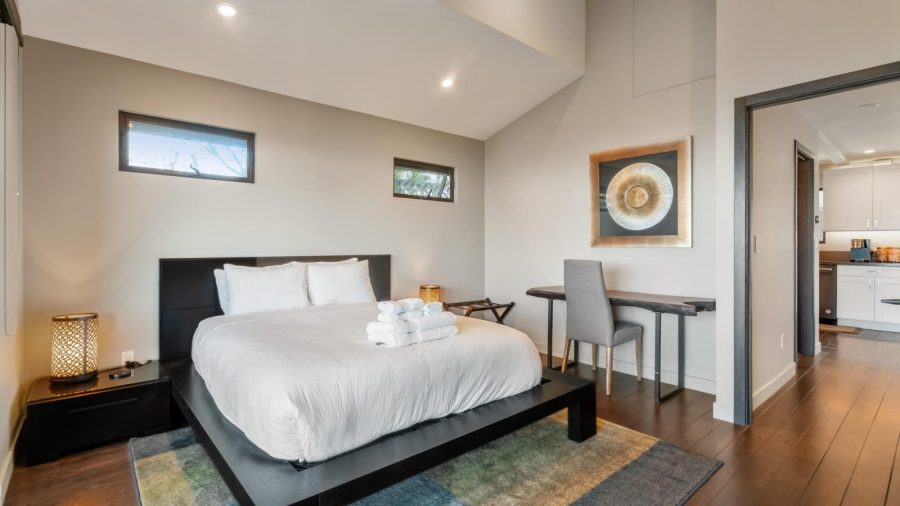 Upstairs bedroom with queen bed and access to upper deck with outstanding views