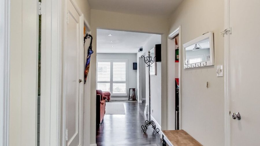 Hallway leading from door to basement (laundry) - across from the entrance door - into the living room, kitchen and dining room.