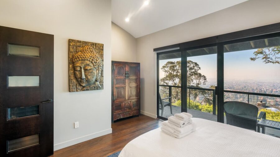 Upstairs bedroom with queen bed and access to upper deck with outstanding views