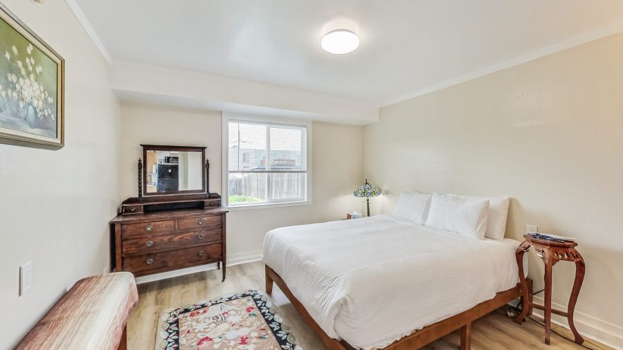 Spacious bedroom with window onto the back yard