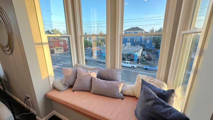 The living room features a cozy bay window with ample light and sunshine; take a break in the sunshine or relax and read a novel