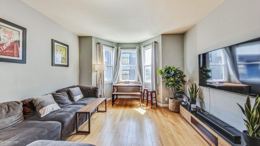 Spacious living room with comfy sofa, dining table and television. 