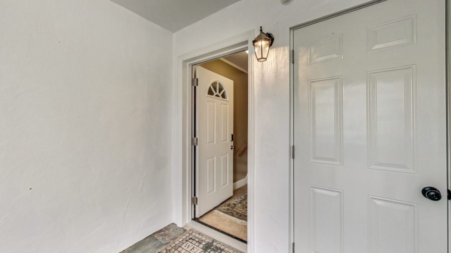 Once inside the gate there is a door to go upstairs, which has 3 bedrooms and 1 bath there is also an entry to the lower level which has 1 bedroom and 1 bath , and a door to the laundry room.