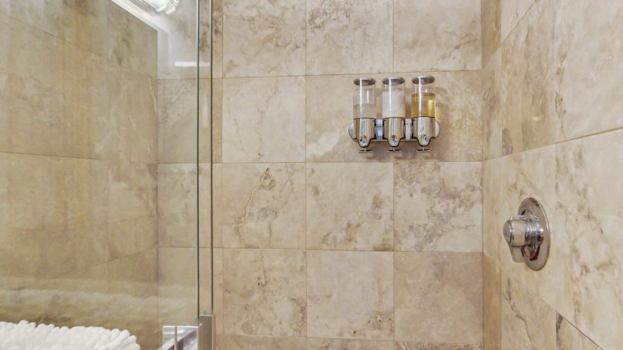 Spacious walk-in  shower with glass shower door.  Lots of light gets into the shower where you will enjoy Kiehl's bath products.