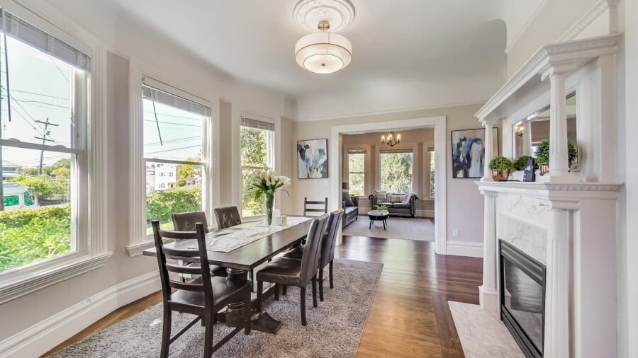 Spacious dining room with decorative fireplace and plenty of room for Eight people