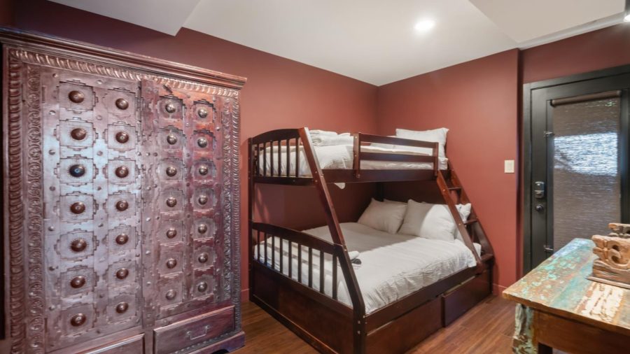 The bonus/kids bedroom, with twin-over-full bunk bed, is accessible from the lower left bedroom and has an exterior door accessible from the side deck via the smart lock and your entry code.  This bedroom shares a bathroom with the lower left bedroom.