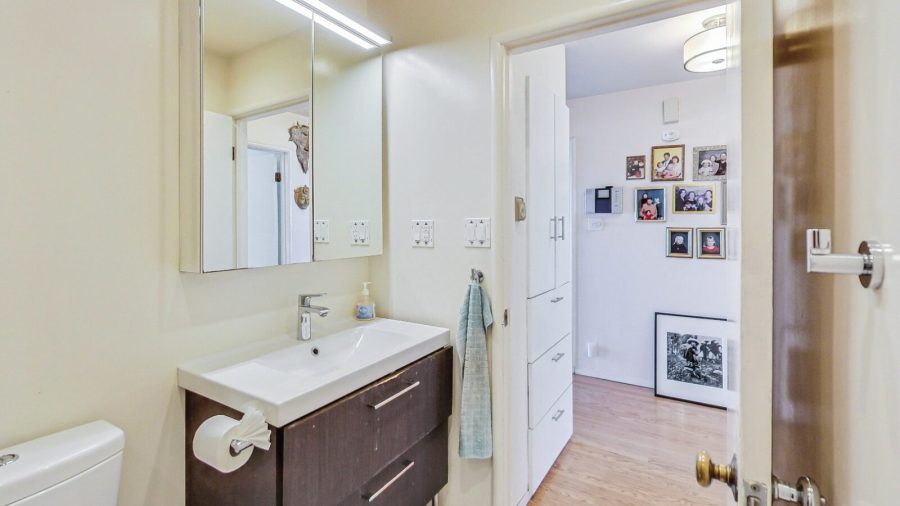 Bathroom is between the bedrooms and living room.