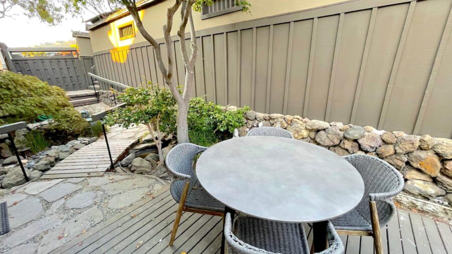 The front patio/deck is located in a secluded courtyard hidden away from street view and doubles as the main entrance to the home
