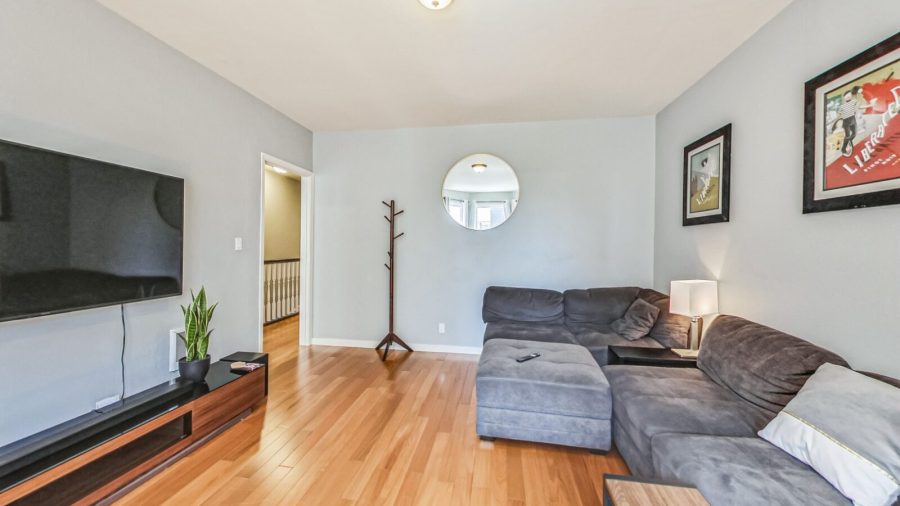 Spacious living room with comfy sofa, dining table and television. 