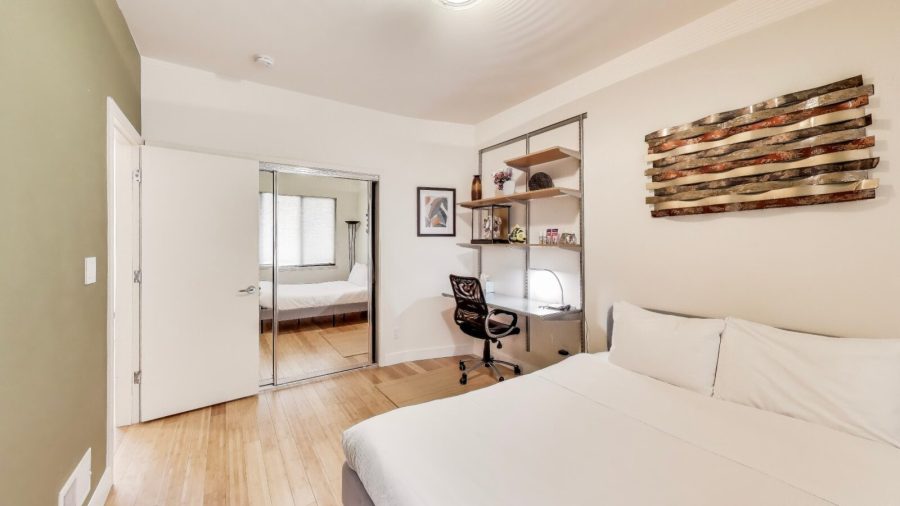 Bedroom with queen bed and laptop friendly desk
