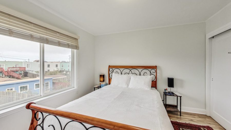 Third bedroom At the end of the hall in the back of the house is a bedroom with a Queen bed.   End Table lamps with USB ports for easy device charging