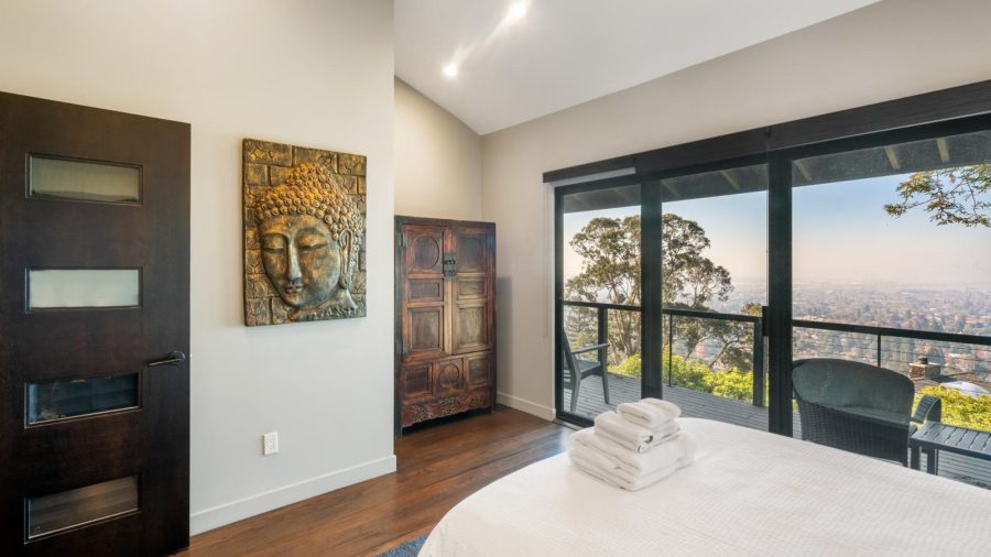 Upstairs bedroom with queen bed and access to upper deck with outstanding views