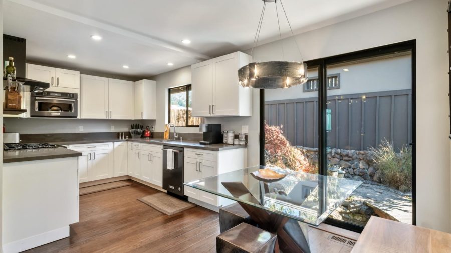 The well-appointed kitchen includes breakfast nook seating with garden views
