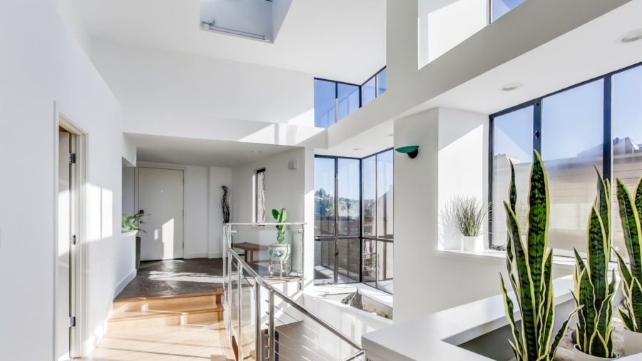 A bright, open, and welcoming entry way with a staircase to the bedrooms on the lower level of the home