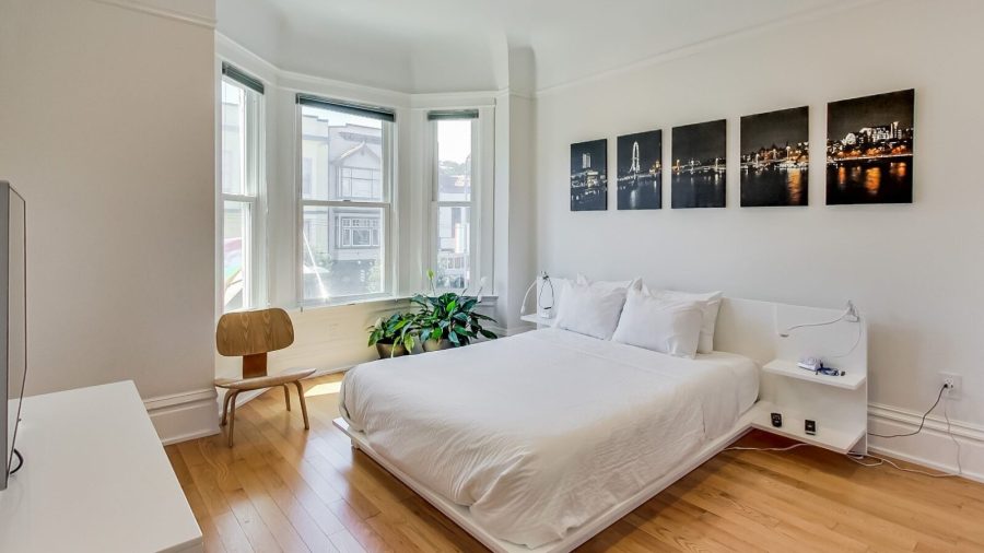 Large and bright bedroom with queen-sized bed, view overlooking Castro St. and 18th, TV with Dish Network and Netflix...