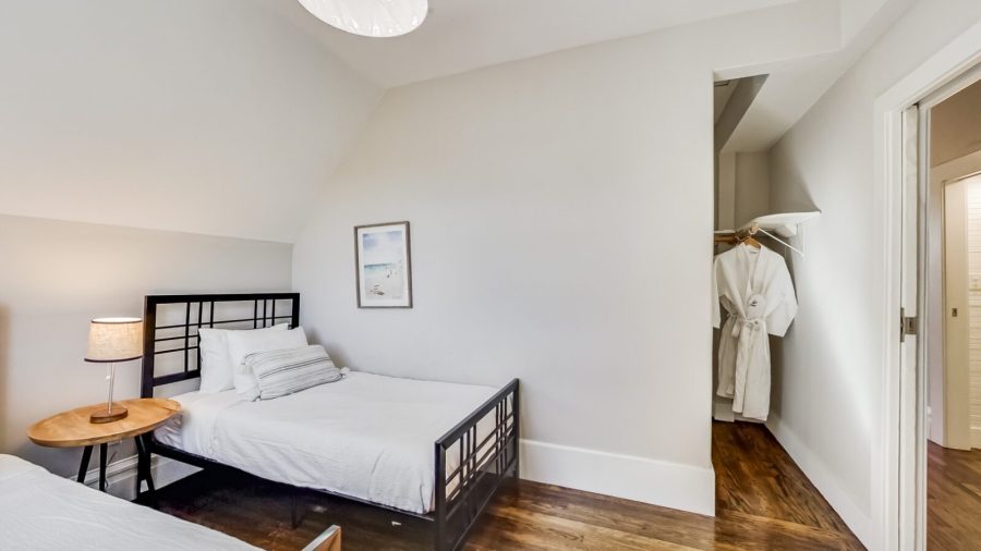 The back upstairs bedroom is just next to the bathroom and features two twin beds and a large closet