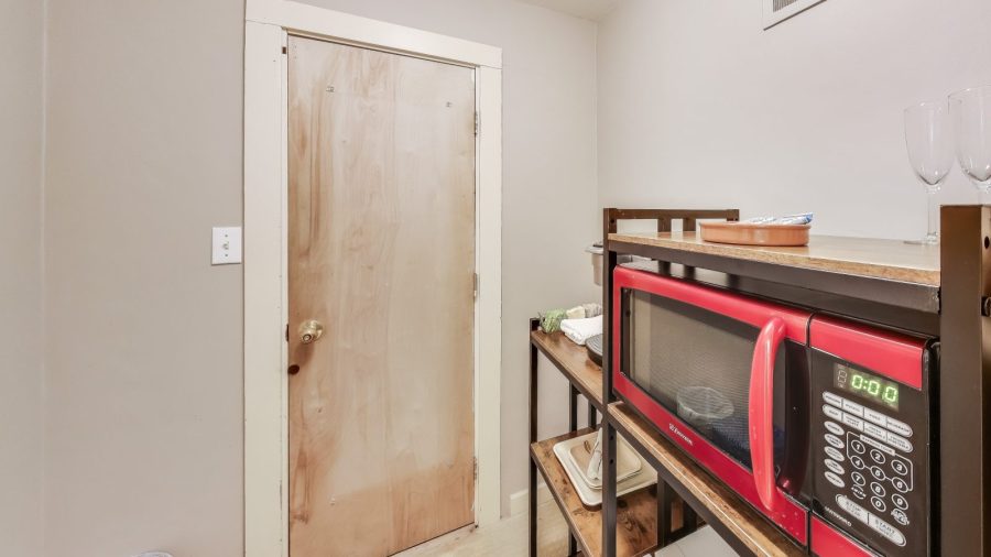 Entry area has coat rack, microwave and coffee station.