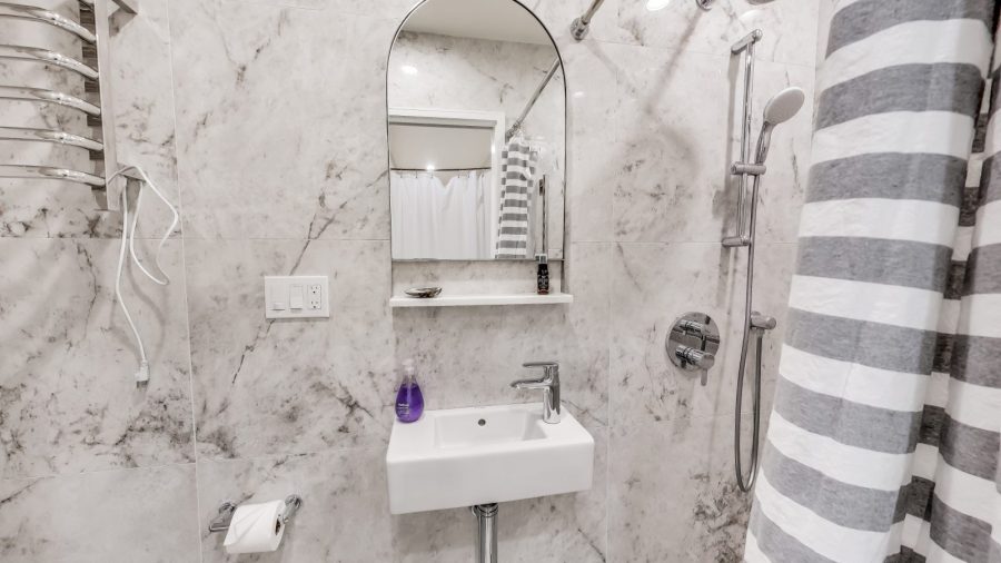 The cozy bathroom has a full shower with removable shower arm for a spa like shower.